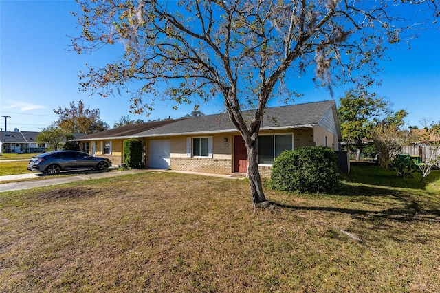 ranch-style house featuring a front yard and a garage