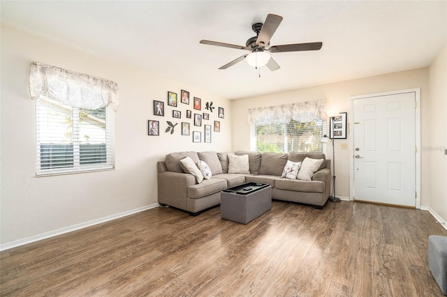 living room featuring hardwood / wood-style floors and ceiling fan