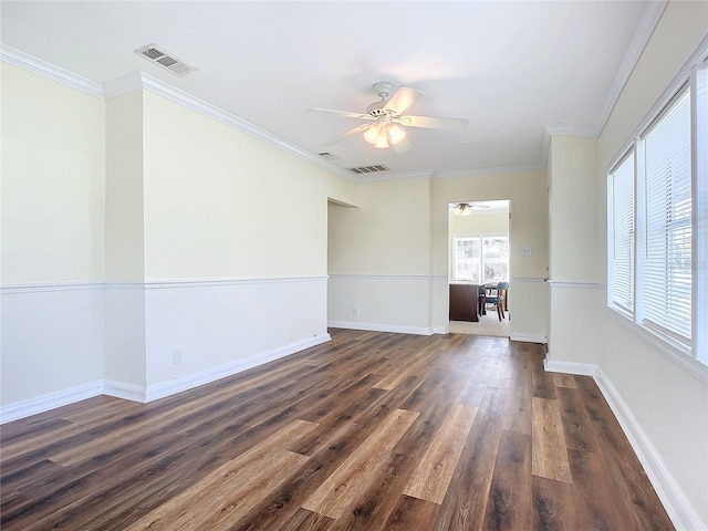 empty room featuring crown molding, ceiling fan, and dark hardwood / wood-style floors