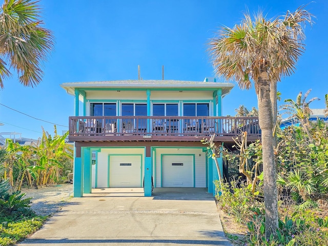 beach home with a wooden deck and a garage