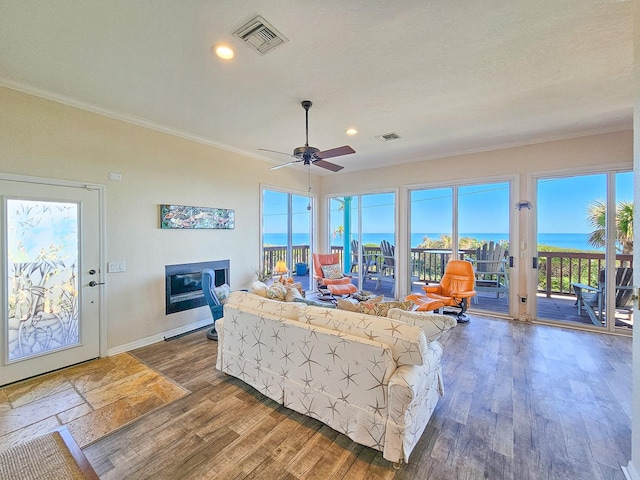 living room with ornamental molding, ceiling fan, and a healthy amount of sunlight