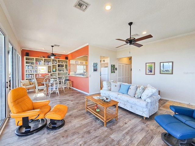 living room with crown molding, ceiling fan, and hardwood / wood-style flooring