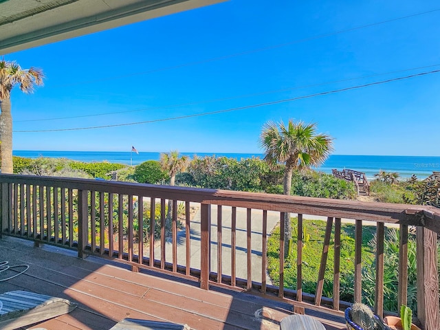 wooden terrace featuring a water view