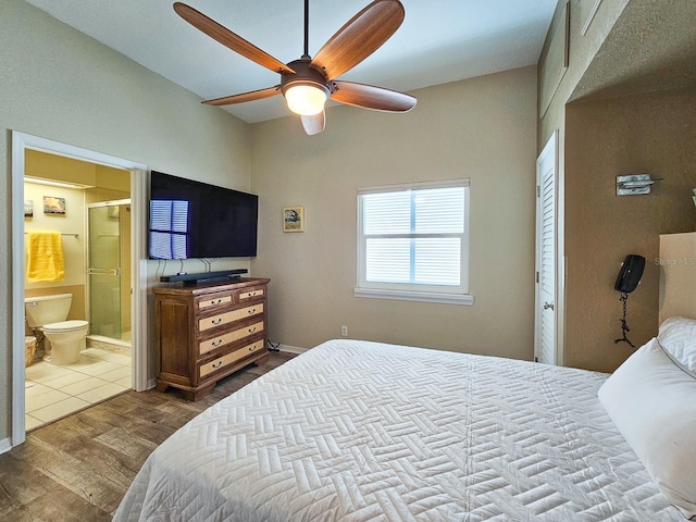 bedroom with wood-type flooring, connected bathroom, and ceiling fan