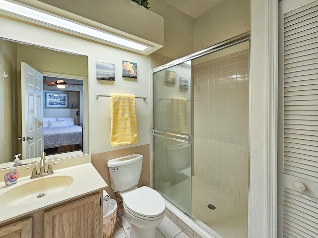 bathroom with tile patterned floors, vanity, toilet, and an enclosed shower