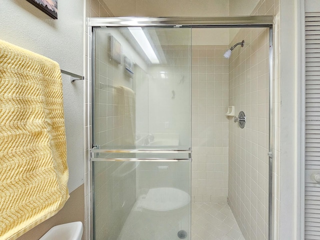 bathroom featuring toilet and walk in shower