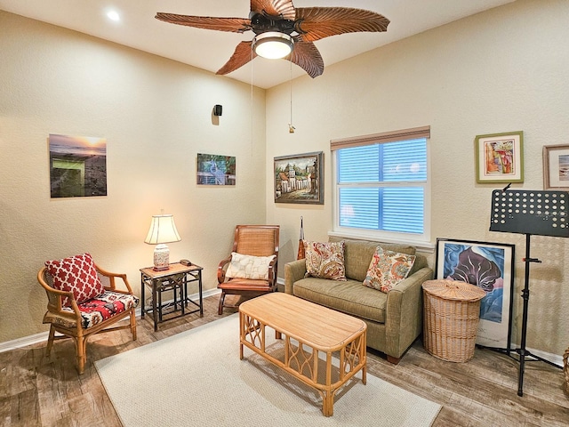 living room featuring hardwood / wood-style floors and ceiling fan