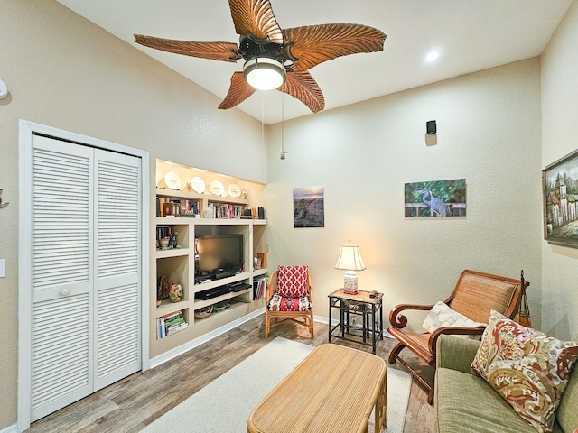 living room featuring hardwood / wood-style floors and ceiling fan