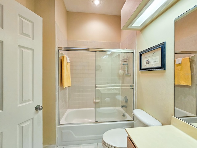 full bathroom with tile patterned floors, vanity, toilet, and enclosed tub / shower combo