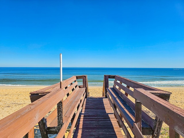 view of community with a water view and a beach view