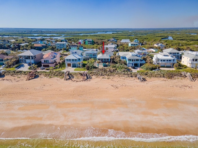 bird's eye view featuring a water view and a view of the beach