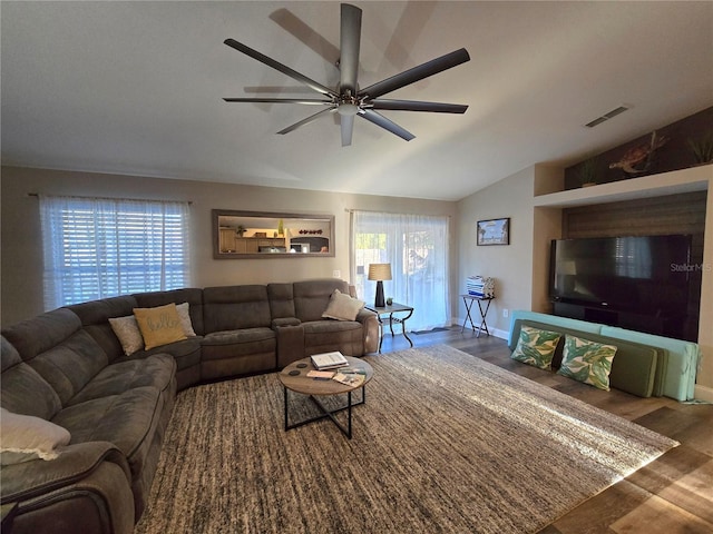 living room featuring hardwood / wood-style flooring, vaulted ceiling, and ceiling fan