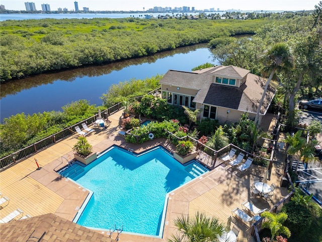 view of swimming pool with a patio area and a water view