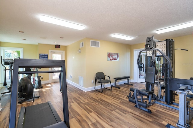 workout area with a textured ceiling and hardwood / wood-style flooring