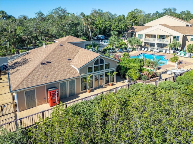 back of property featuring a fenced in pool and a patio area