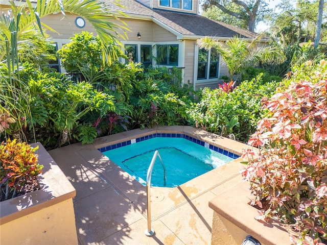 view of swimming pool featuring an in ground hot tub