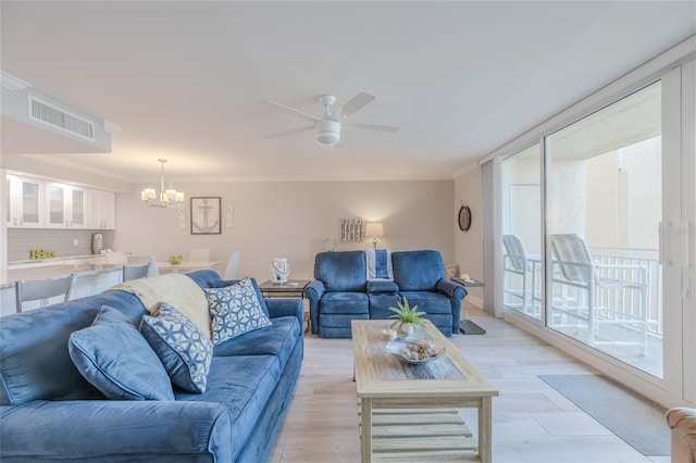 2401 S Atlantic Ave Unit C206, New Smyrna Beach, FL 32169 - living room featuring a chandelier, a ceiling fan, crown molding, and light wood-style floors