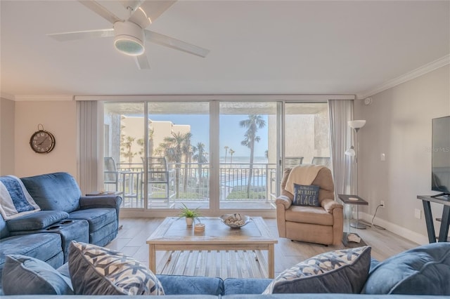 2401 S Atlantic Ave Unit C206, New Smyrna Beach, FL 32169 - living area with light wood-style flooring, plenty of natural light, ornamental molding, and a ceiling fan