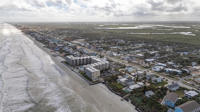 birds eye view of property with a water view and a view of the beach