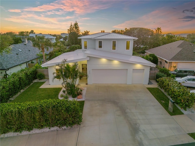 view of front of house featuring a yard and a garage