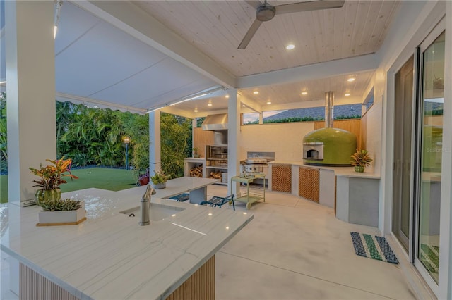 view of patio featuring an outdoor kitchen and ceiling fan