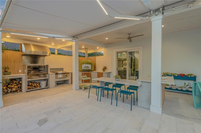 view of patio / terrace featuring ceiling fan and a bar