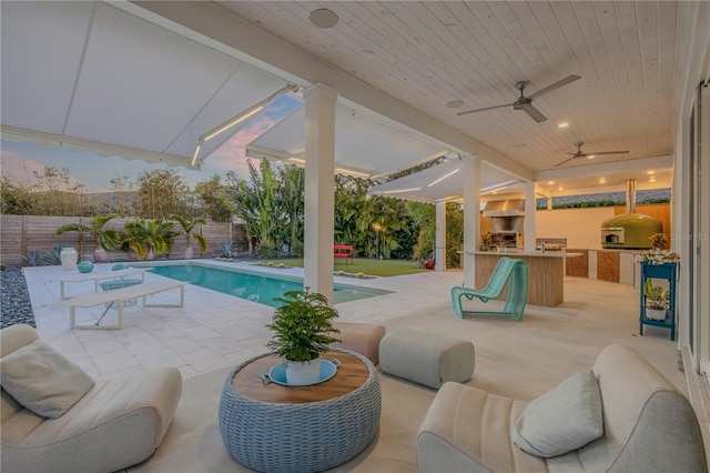 view of swimming pool featuring area for grilling, ceiling fan, and a patio area