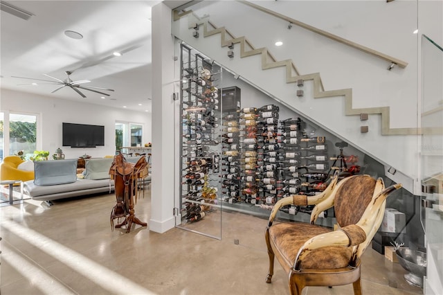 wine area with ceiling fan and concrete flooring