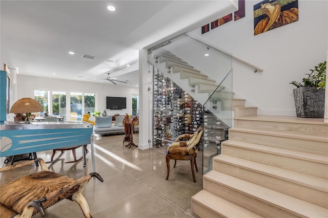 interior space with ceiling fan and concrete floors