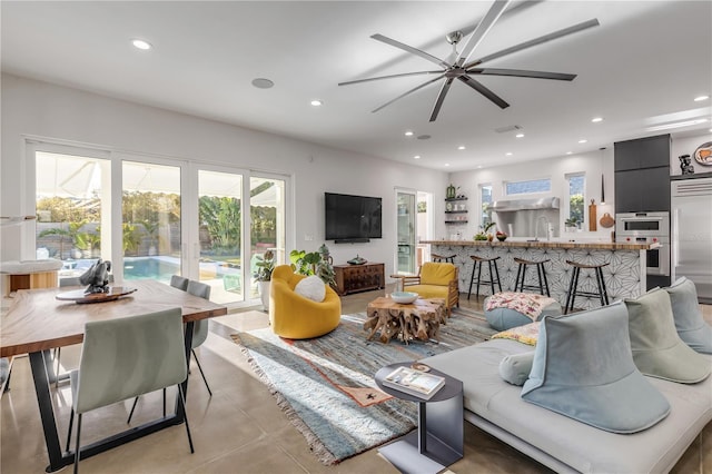 living room featuring ceiling fan and sink