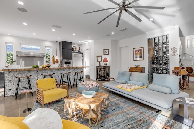 living room featuring ceiling fan and sink