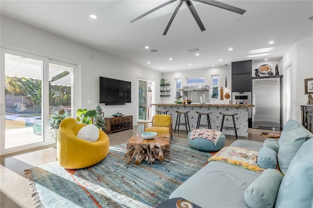 living room featuring light wood-type flooring and ceiling fan