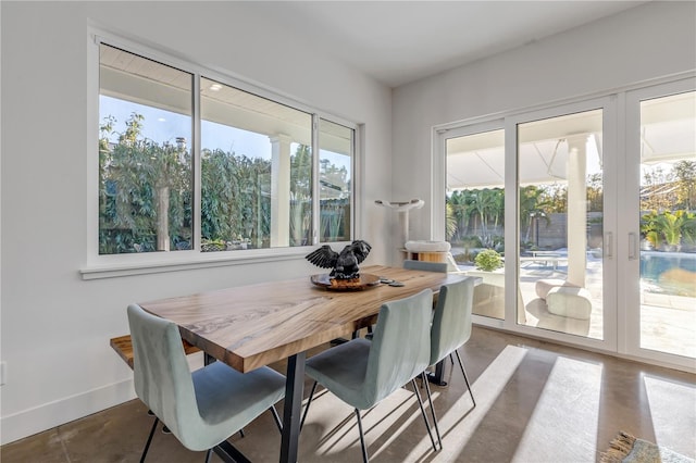 dining space featuring concrete floors