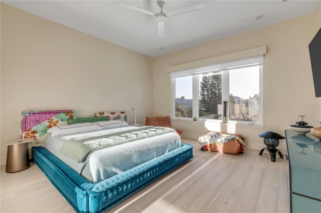 bedroom with ceiling fan and wood-type flooring