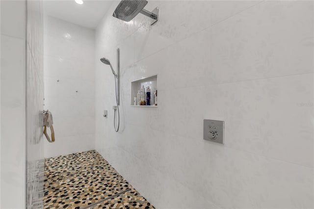 bathroom with a tile shower