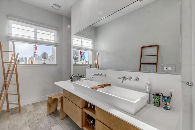 bathroom with hardwood / wood-style flooring and sink