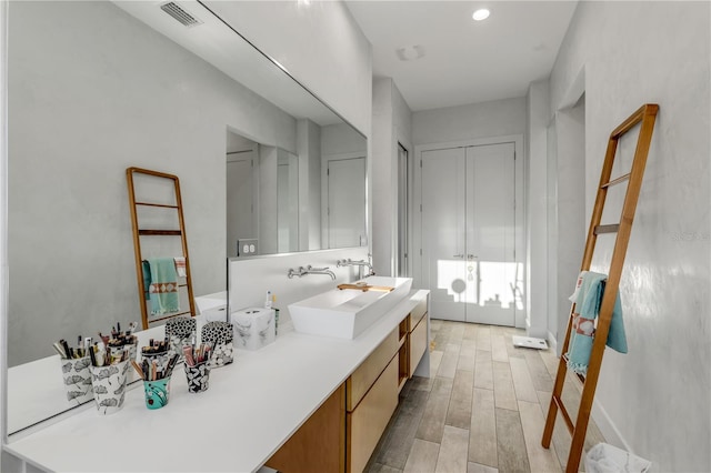 bathroom featuring hardwood / wood-style floors and vanity