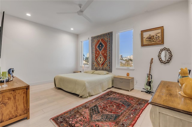 bedroom with ceiling fan and light hardwood / wood-style floors