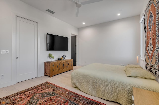 bedroom with ceiling fan and light hardwood / wood-style floors