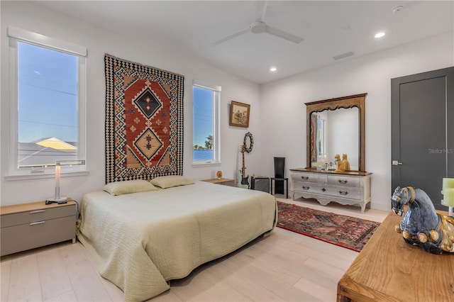 bedroom with ceiling fan and light hardwood / wood-style floors