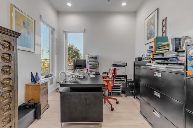 home office with a healthy amount of sunlight and light wood-type flooring