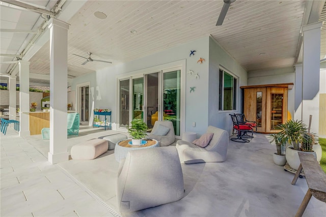 view of patio featuring ceiling fan, an outdoor living space, and french doors