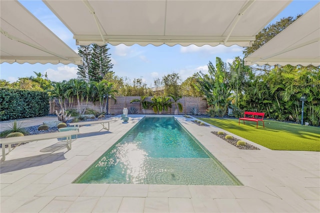 view of swimming pool with a patio and a lawn