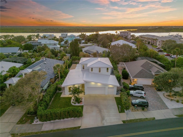 aerial view at dusk with a water view