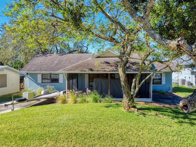 ranch-style house featuring a front lawn and central air condition unit