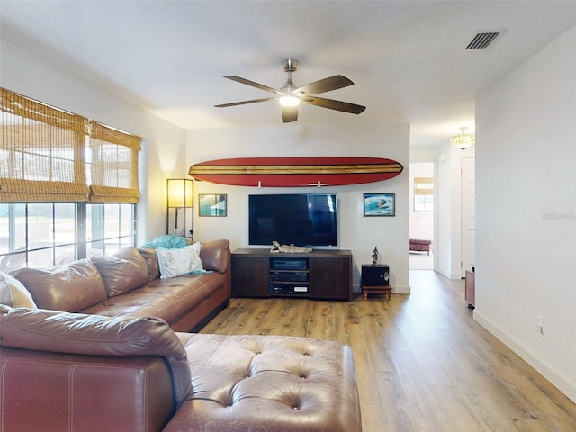 living room featuring ceiling fan and light wood-type flooring