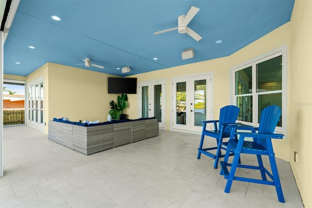 view of patio with ceiling fan, french doors, and an outdoor living space