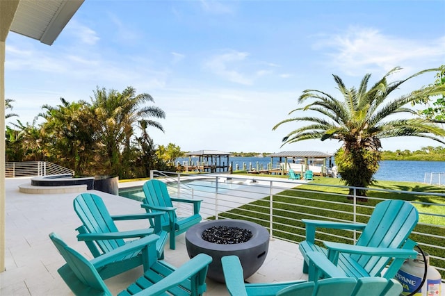 view of patio / terrace featuring a water view and an outdoor fire pit