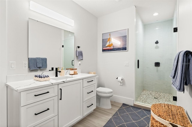 bathroom featuring vanity, hardwood / wood-style flooring, toilet, and walk in shower