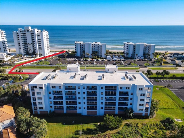 bird's eye view featuring a water view and a view of the beach